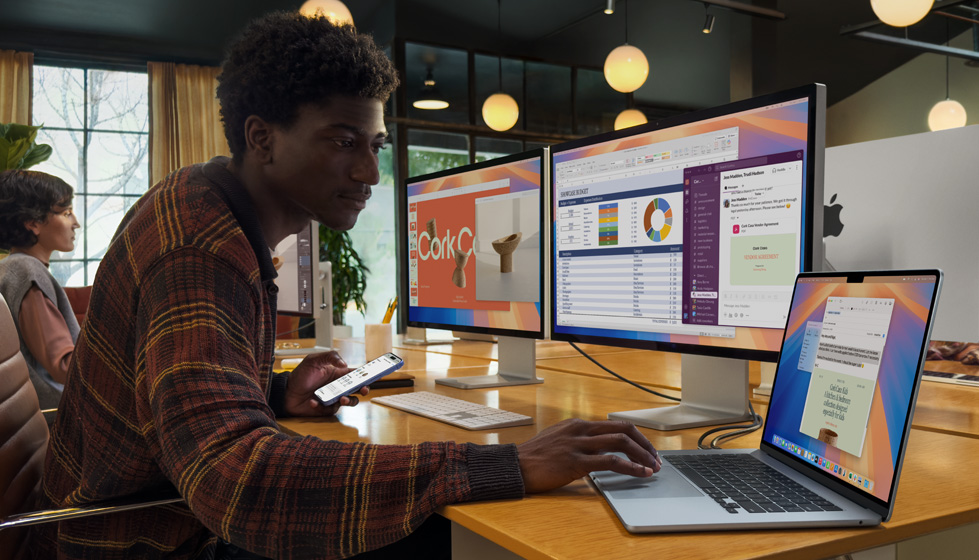 Man working with Apple devices